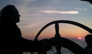 Red Witch Captain at the Helm at sunrise